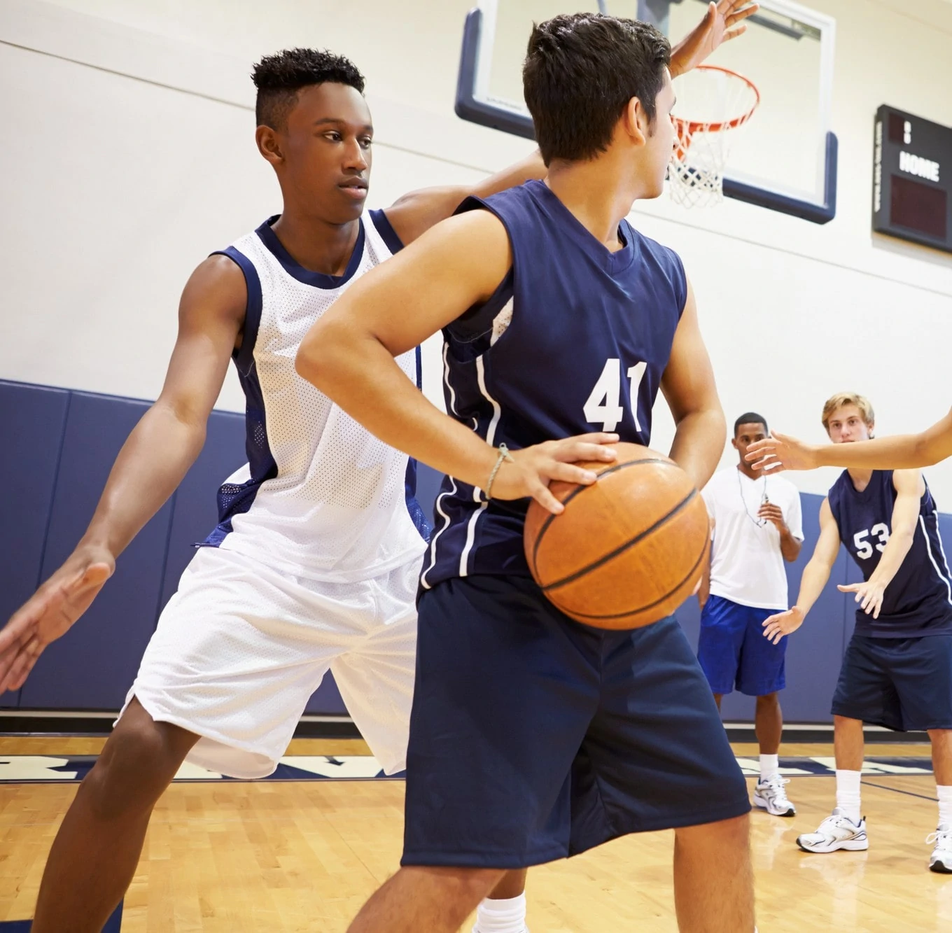 Several boys playing basketball on a court