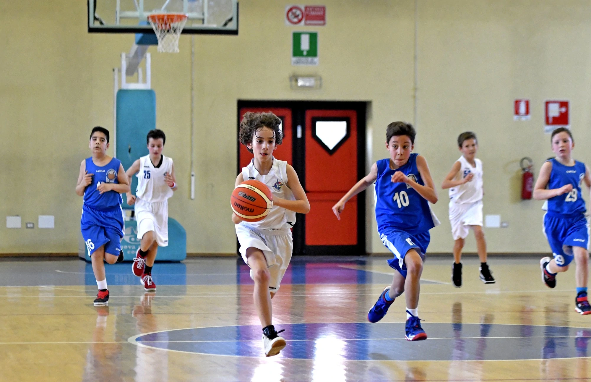 A group of young boys playing basketball