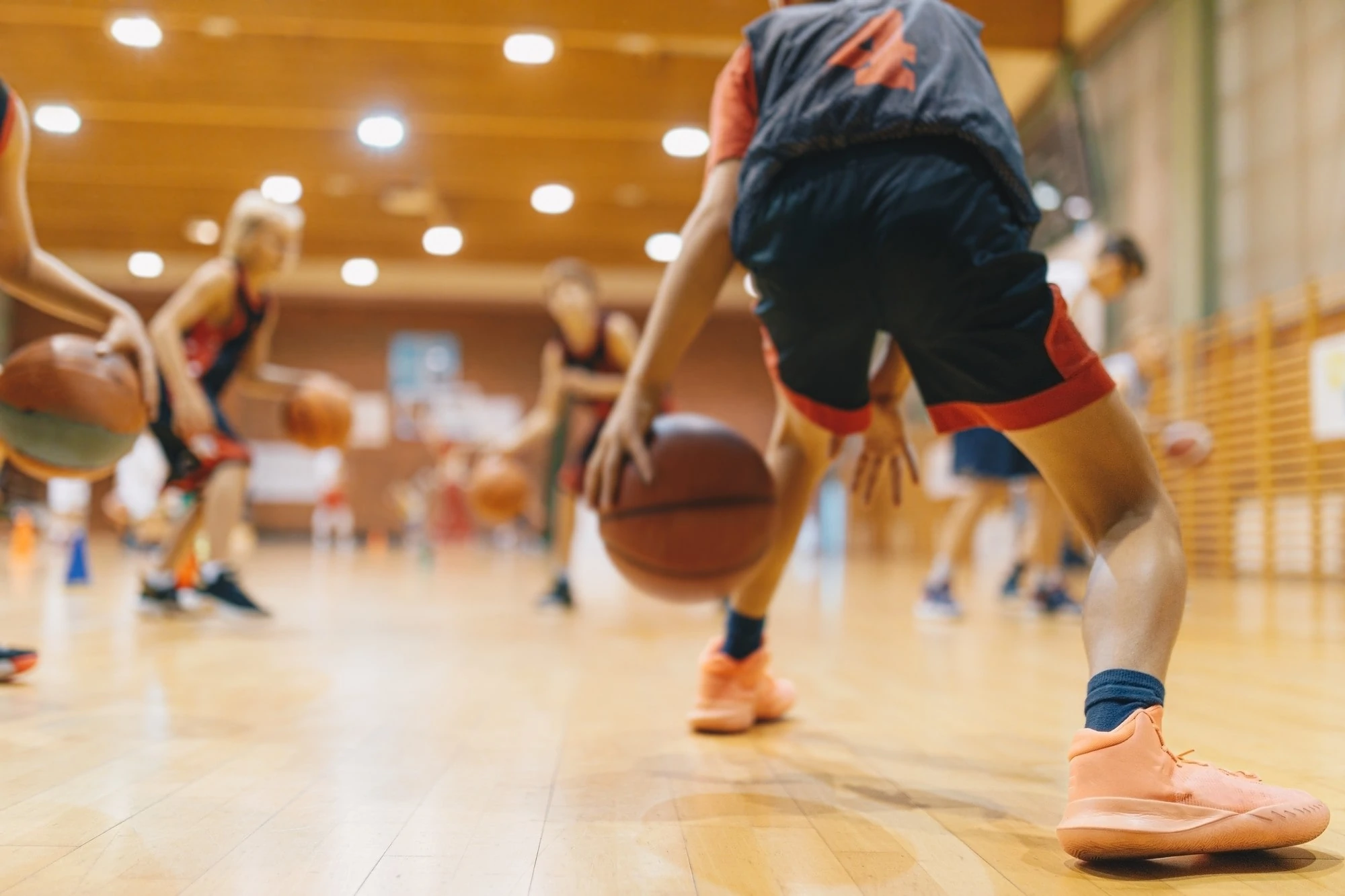 Young individuals playing basketball on a court